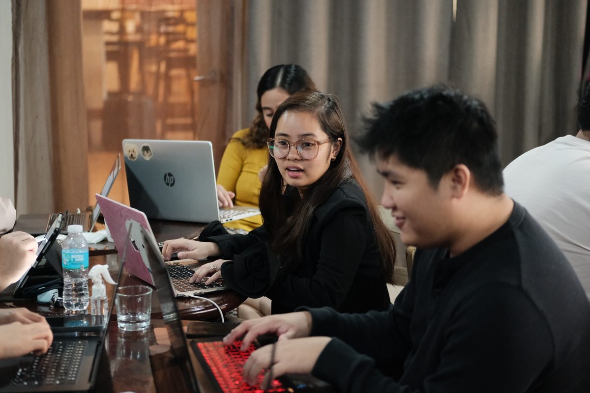 Business owners building their own AI systems on laptops during an AI Hour session