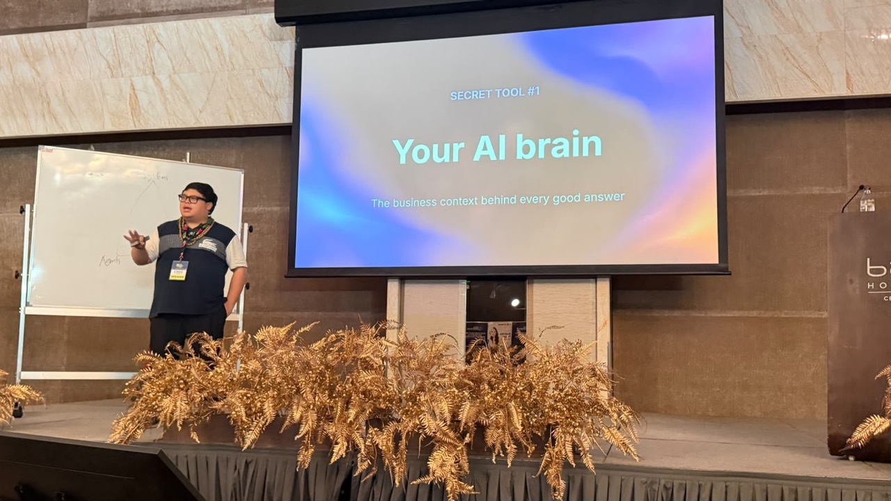 Cris presenting a slide titled Your AI brain at Bai Hotel Cebu